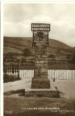 Sign with concrete base and gates behind