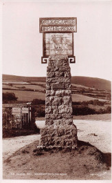 Sign with earth base and gates behind